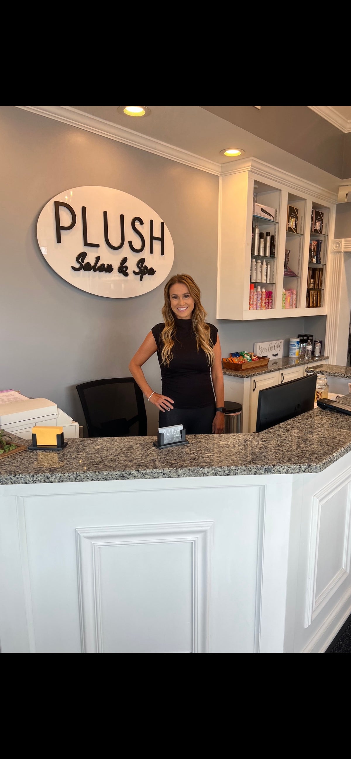 Owner Julie Murphy behind the front desk at Plush Salon & Spa, Oakdale PA