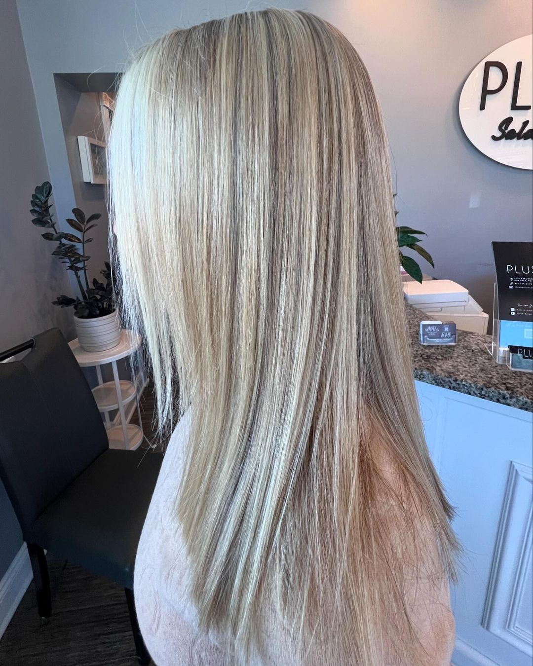 Dimensional blonde highlights blown out straight, at the Plush Salon & Spa front desk in Oakdale PA