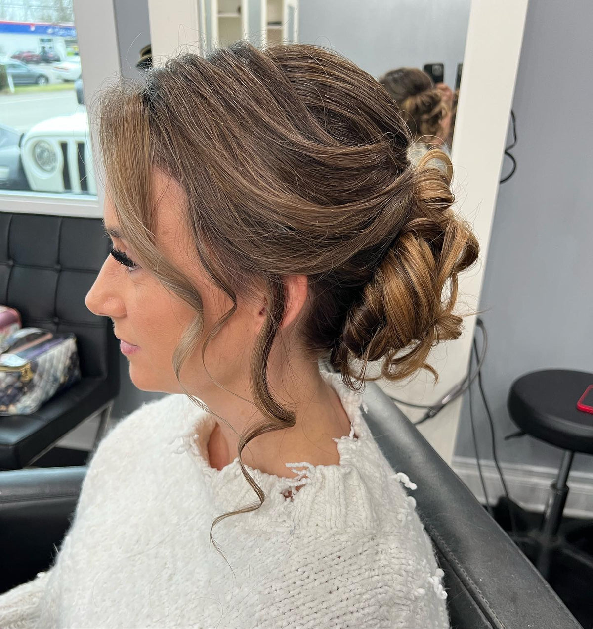 Soft curled low updo with face-framing pieces at Plush Salon & Spa, Oakdale PA