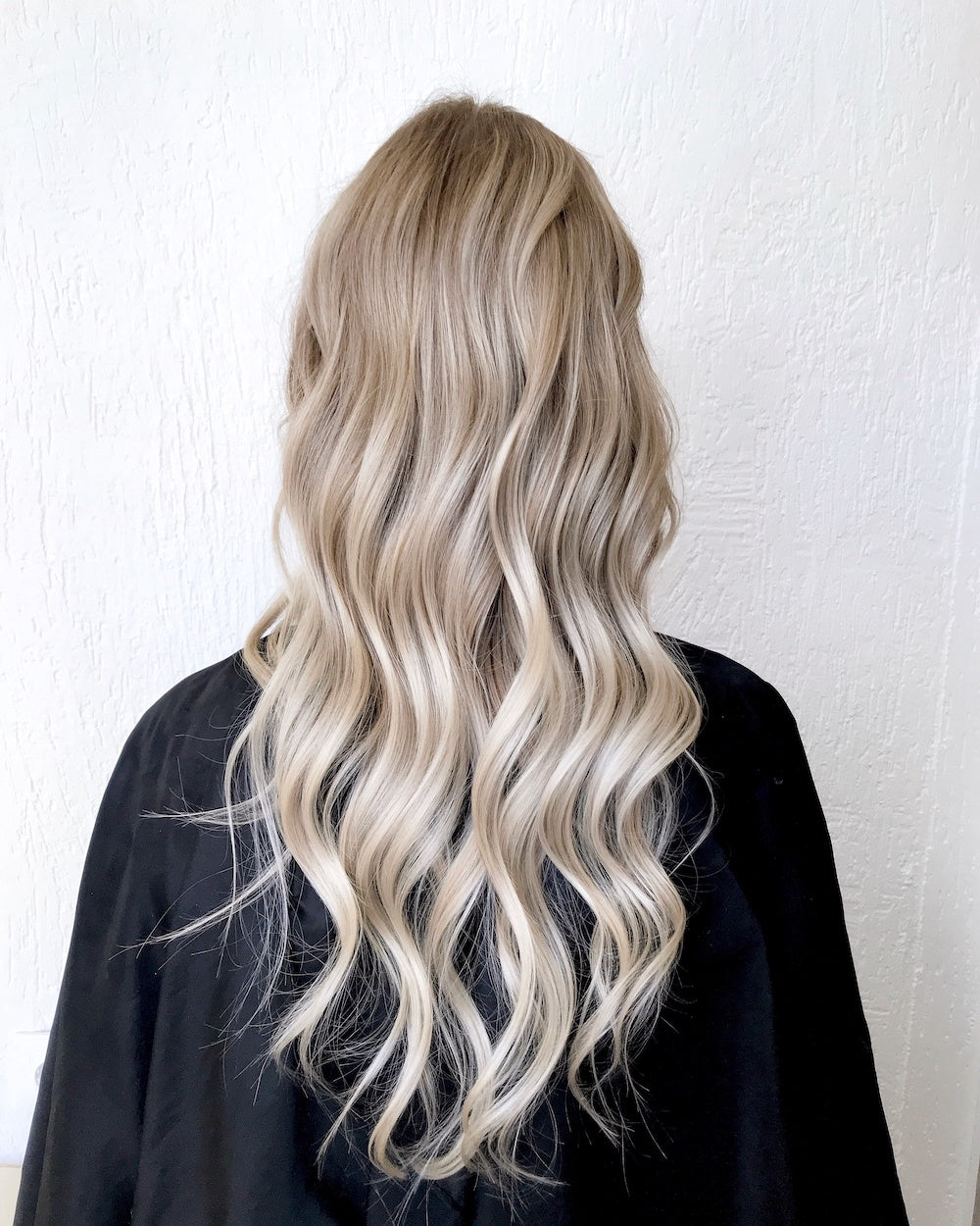 Icy blonde balayage styled in loose beach waves at Plush Salon & Spa, Oakdale PA